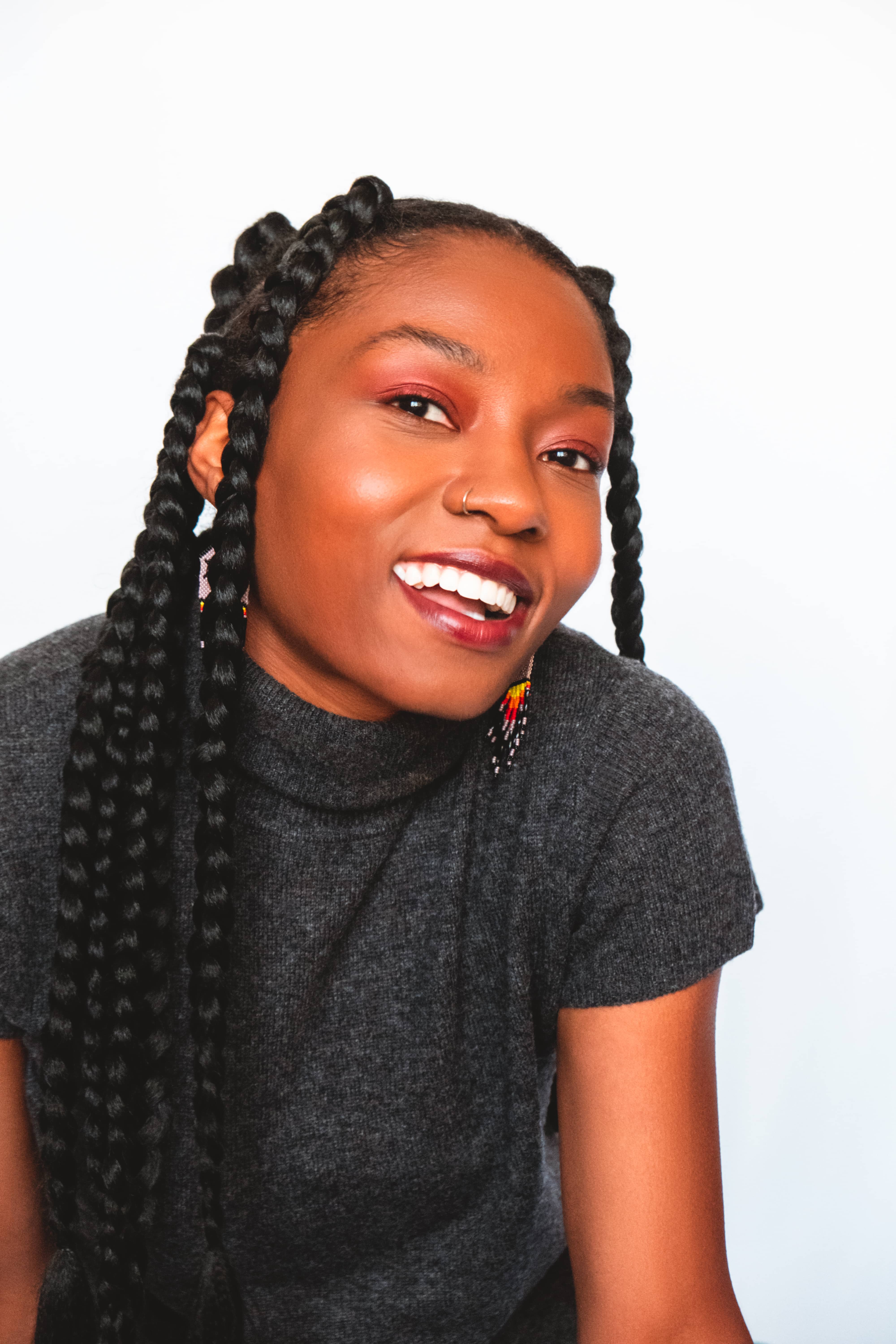 Woman with jumbo box braids smiling, closeup