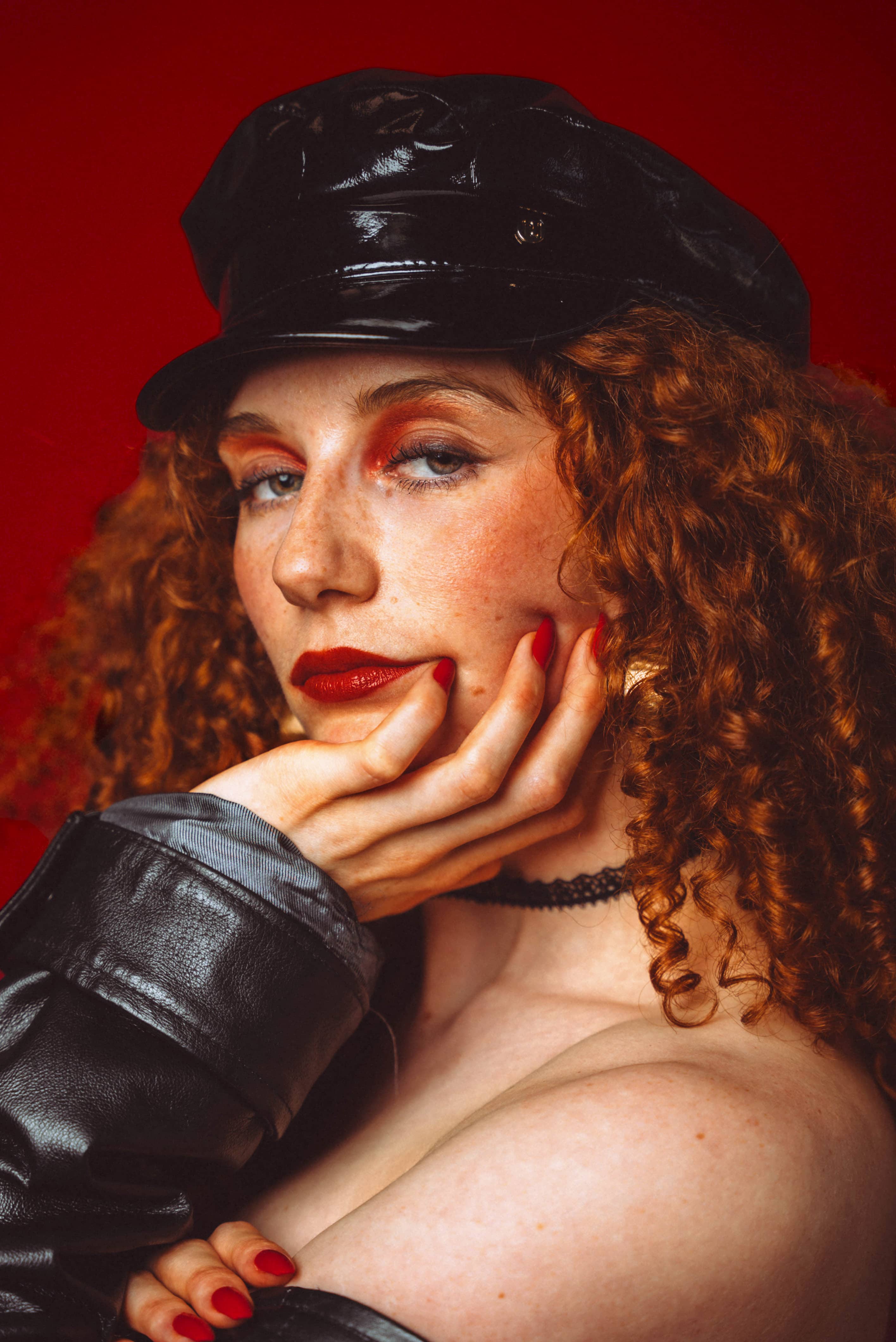 Woman with curly hair, black hat
