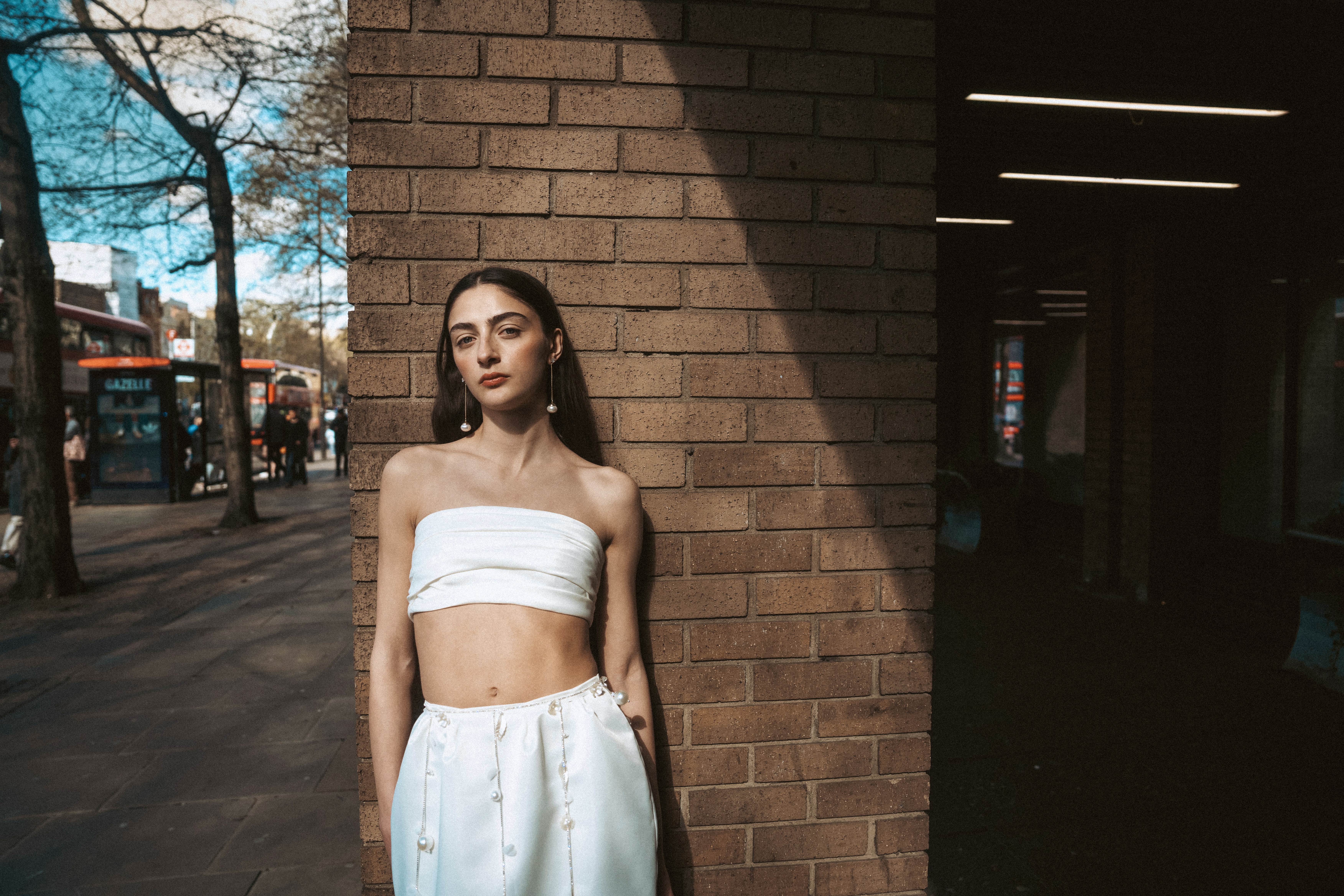 Woman against a brick wall in the city