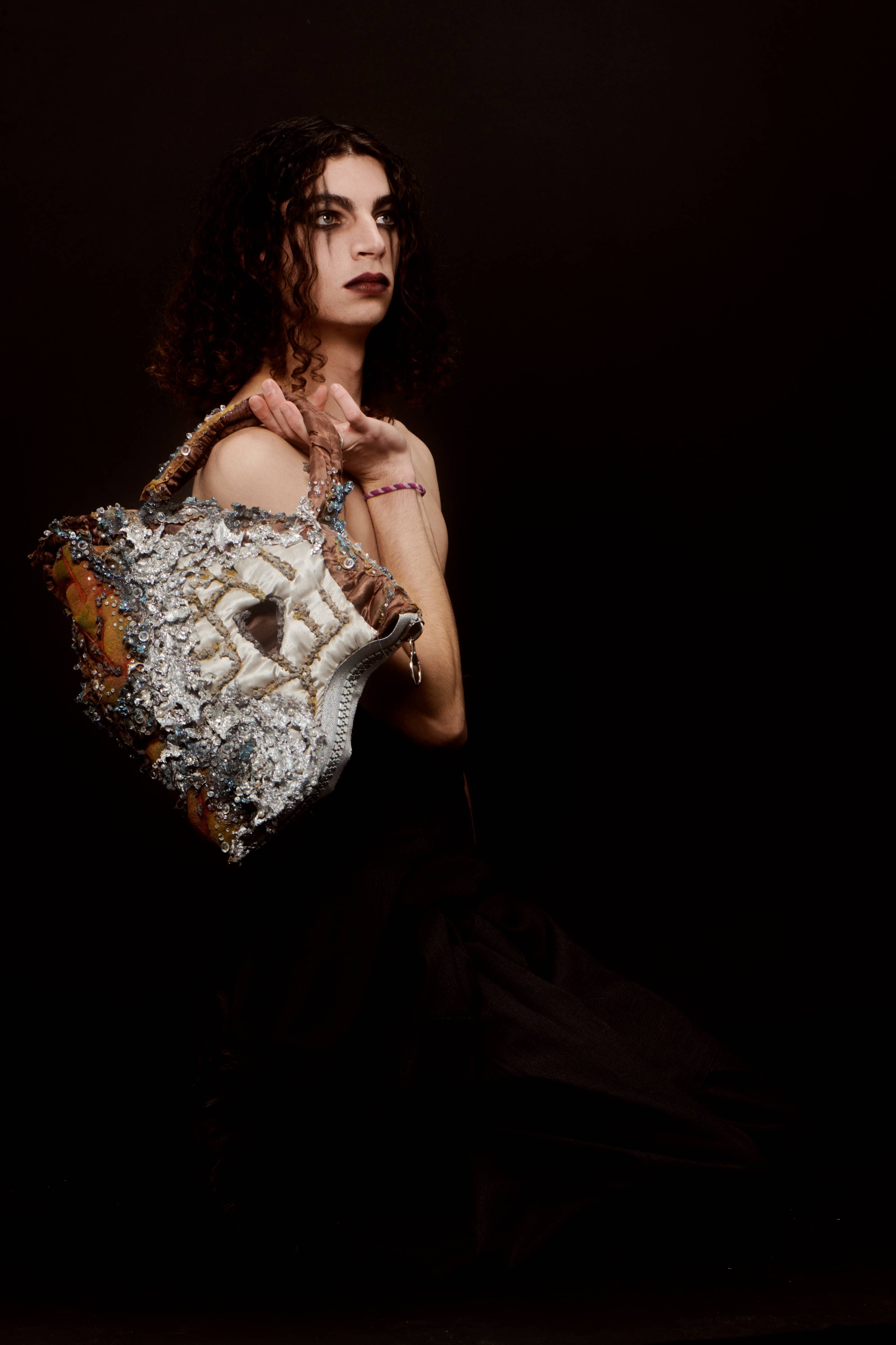 Woman holding a bag, black background