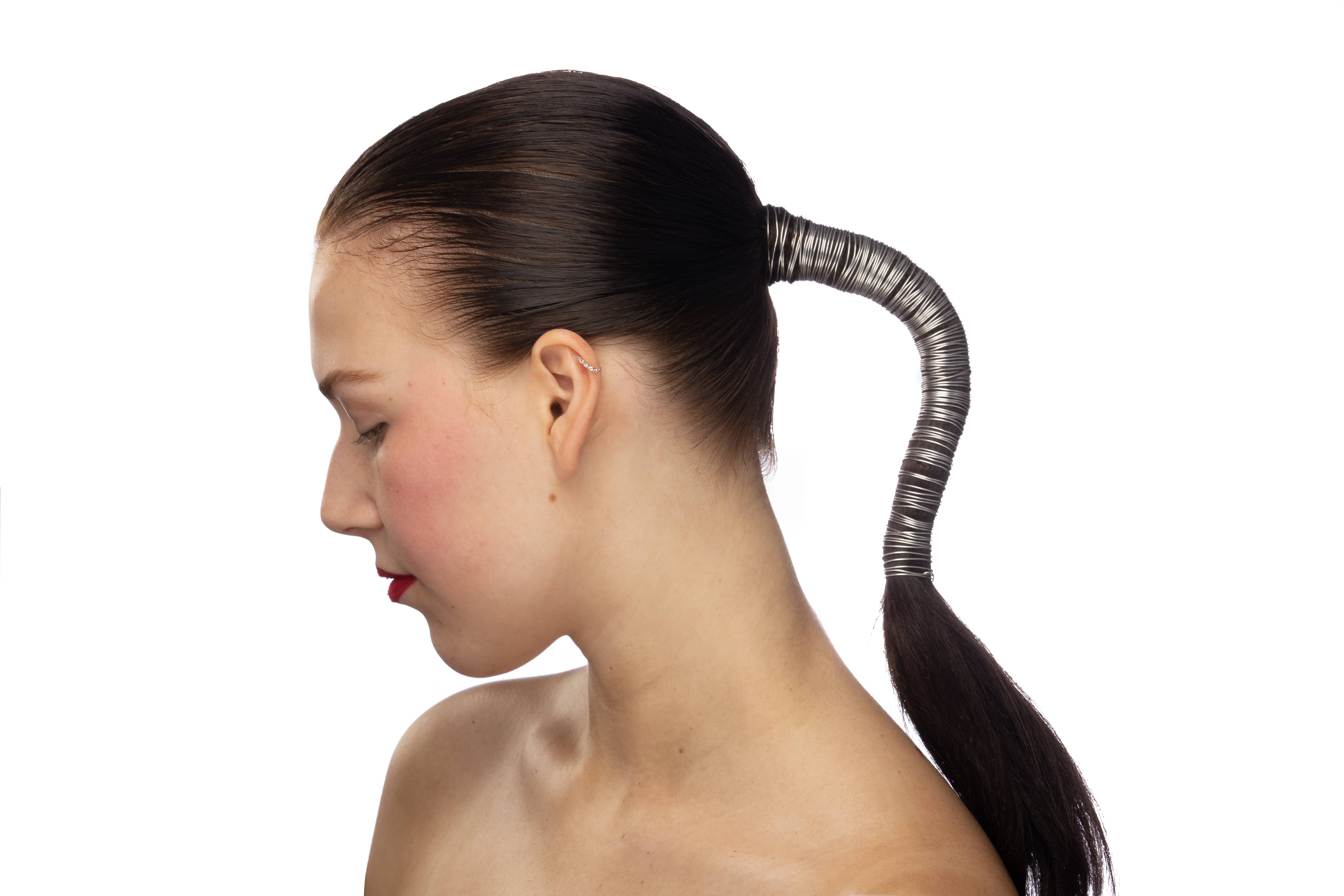 Woman with dark hair tightly tied back