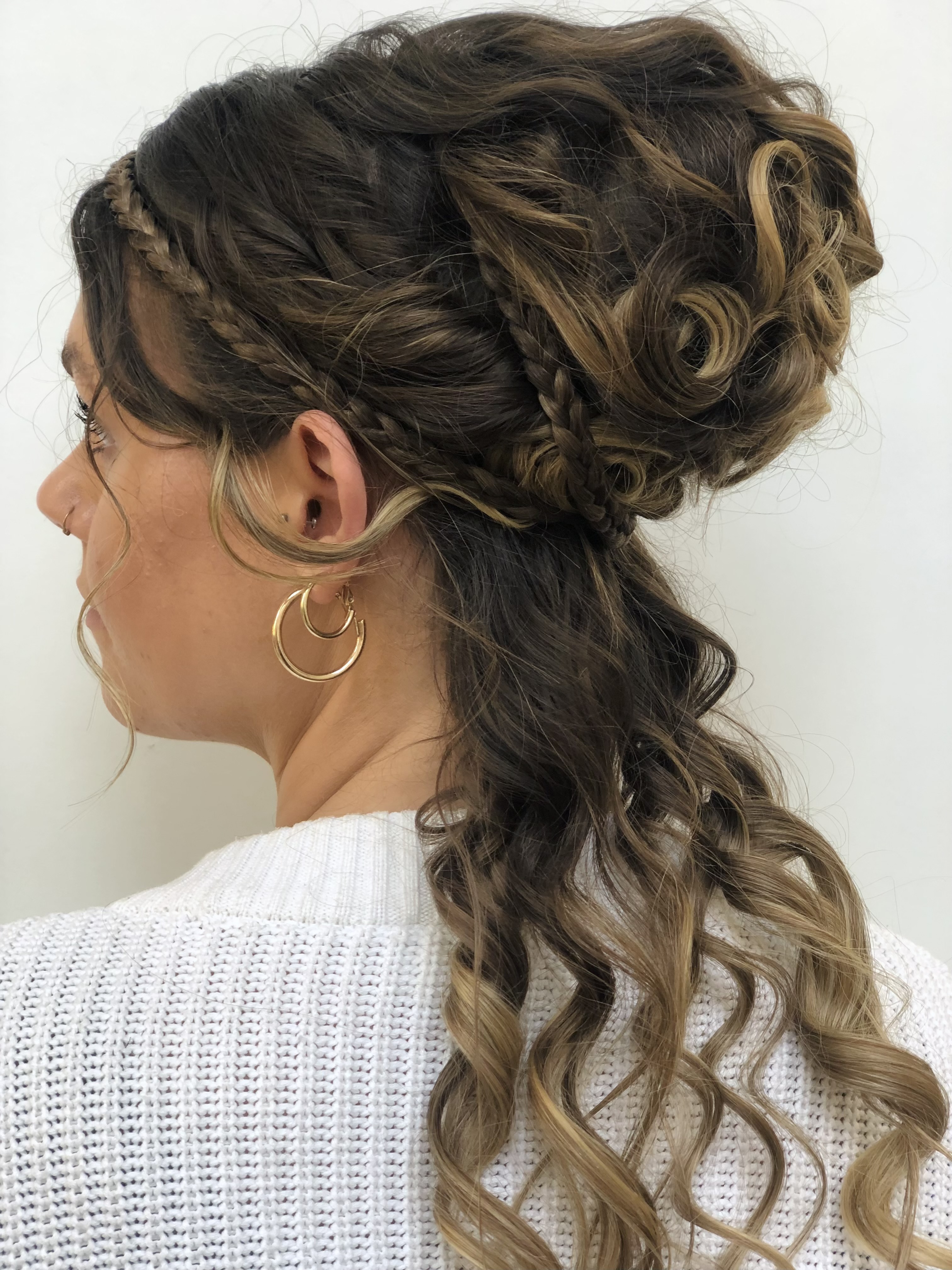 Brown hair with highlights in an elegant up-tie