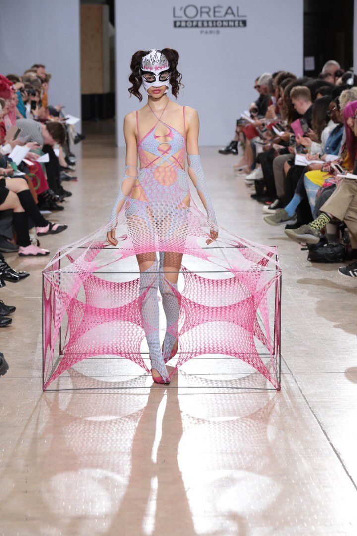 Woman with box clothing in fashion show