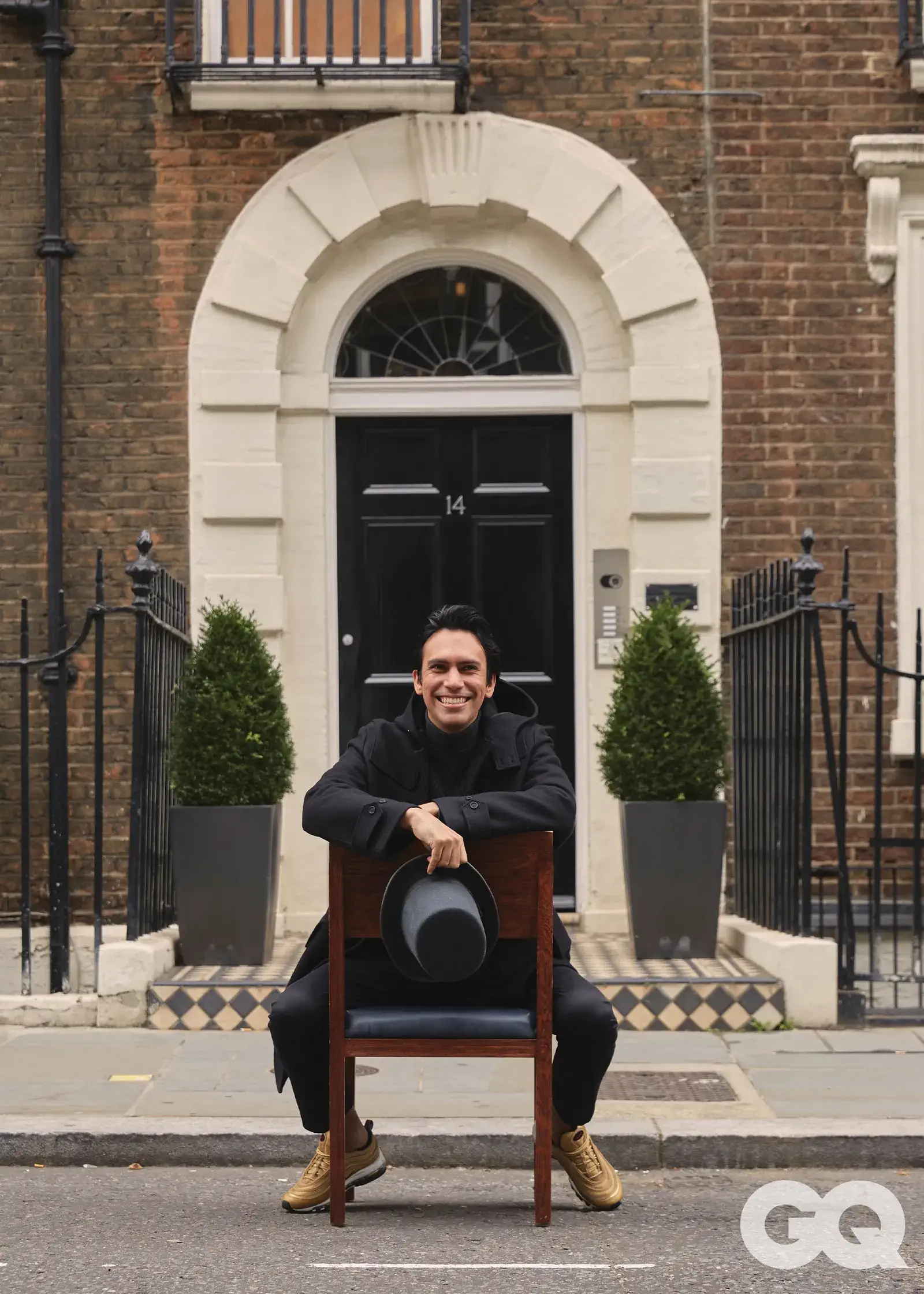 Santiago Lastra sitting in a chair on the street