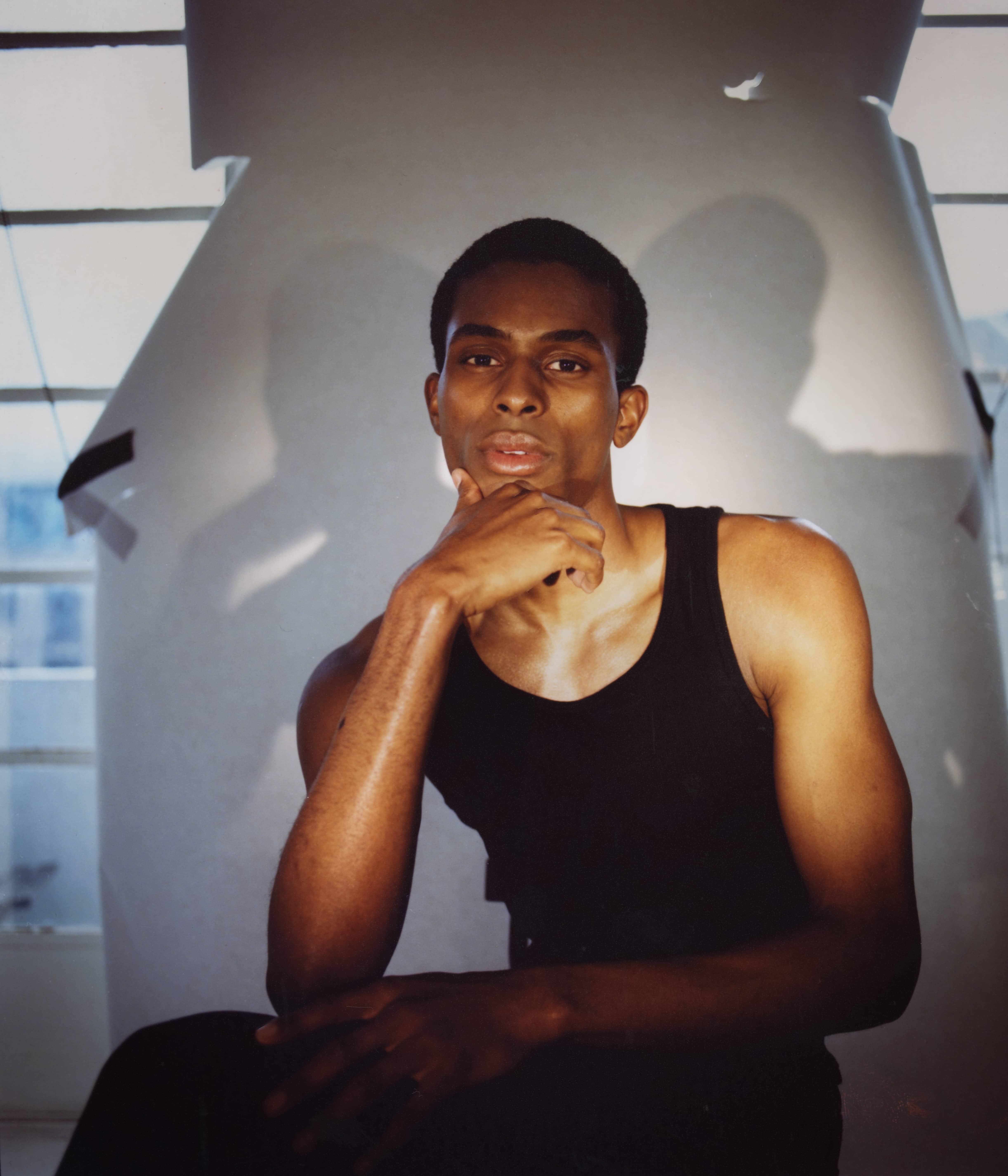 Man with black tanktop and short hair