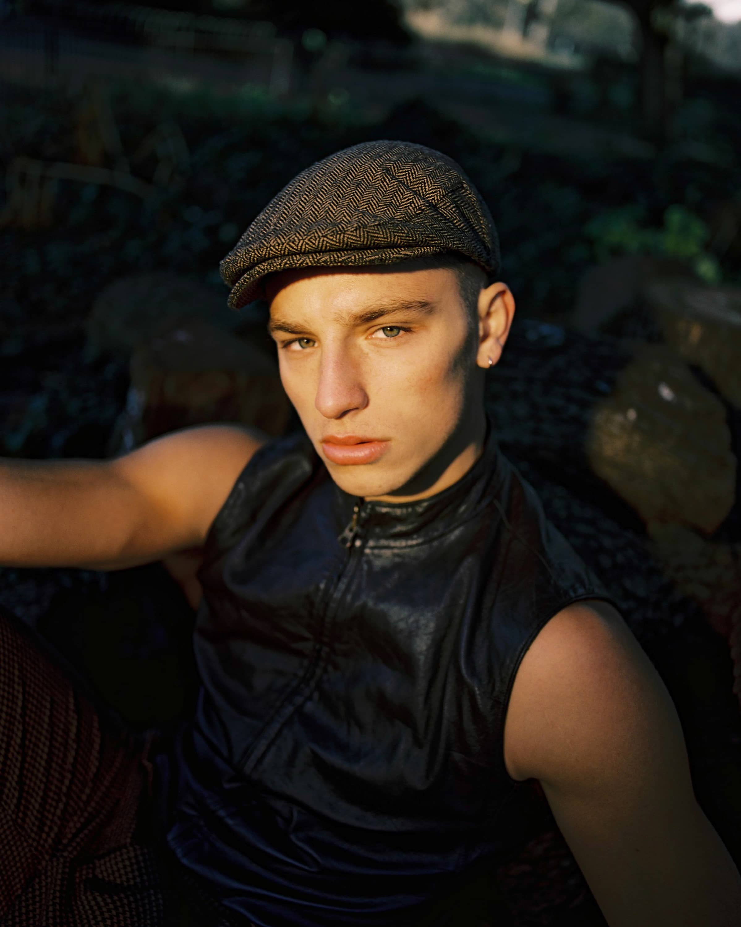 Man in leather vest and a flat cap
